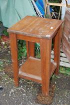 An octagonal table with lower shelf, 18 1/2'' x 31'' high.