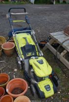 A self propelled Ryobi mower with grass box.