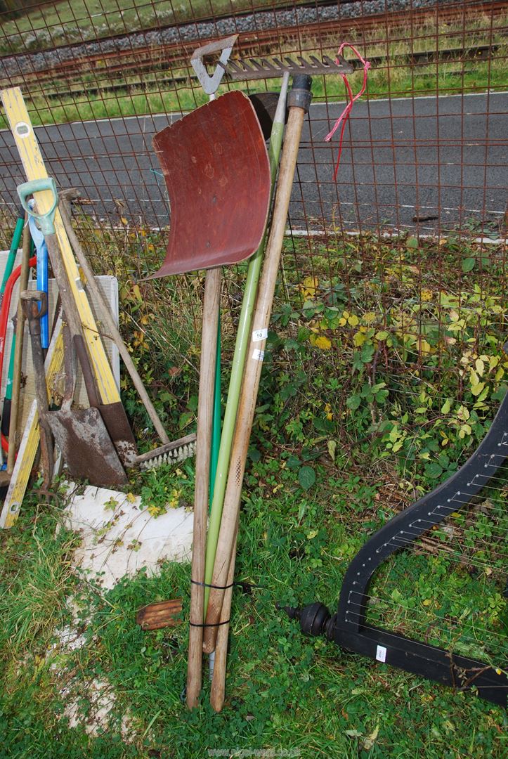 A snow shovel, rake, hoe and a stocker.