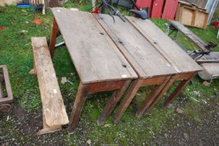 A small wooden bench and three school desks, 40'' wide x 17'' x 28'' high.