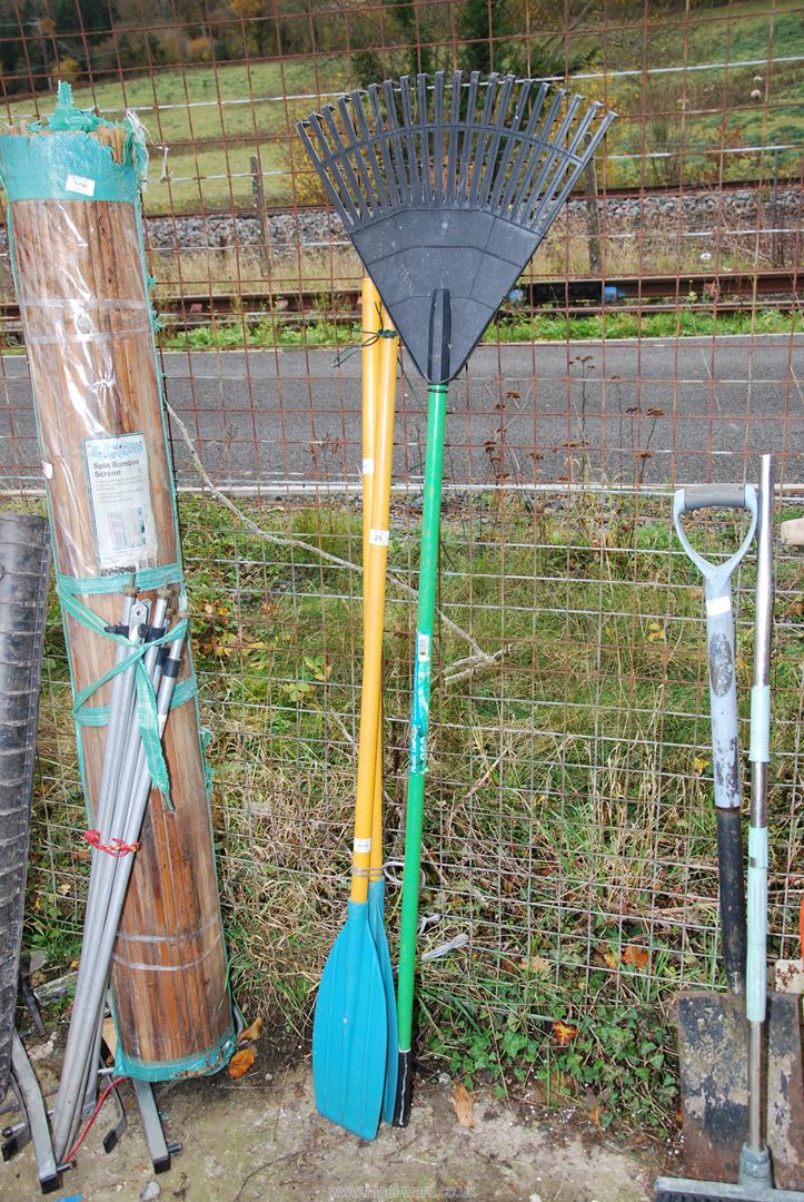 Two oars and a plastic garden rake.