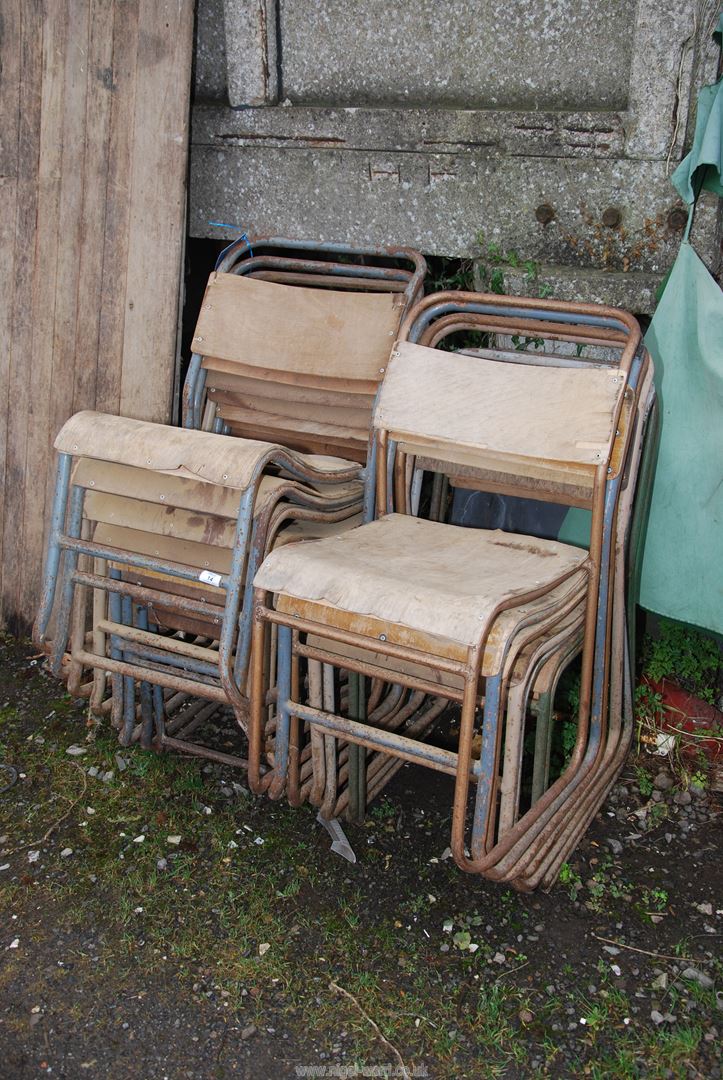 Fourteen vintage stacking chairs.