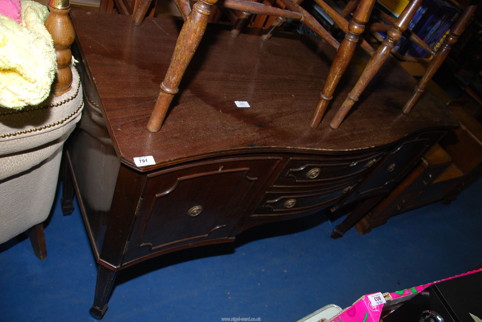 A bow front Mahogany finished sideboard with 2 central drawers flanked by two cupboards - 53½"