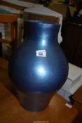 A large blue vase, 18'' tall.