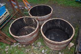 Three half barrel planters.