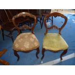 Three dining chairs with upholstered seats.