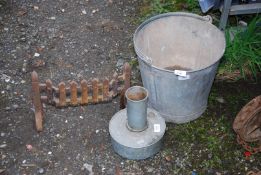 A greenhouse heater, galvanised bucket and a cast iron fire front.