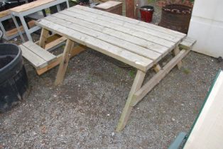 A picnic table with space for a wheelchair.