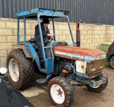 A Ford 1910 4 WD three cylinder 1,702 cc Diesel engined 32 H.P. compact farm tractor.