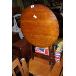 A circular tilt top table.