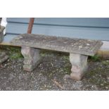 A concrete garden bench on plinth, 45'' wide x 14'' deep x 17'' high.