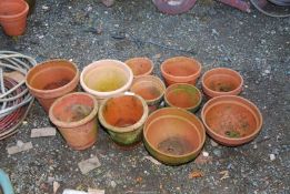 Eleven terracotta pots.