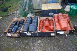 A large quantity of black and brown flower pots.