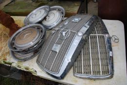 Two Mercedes Benz grills and six wheel trims