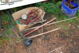 A box of jump leads, hedging bill, bow saw, nail bar etc.