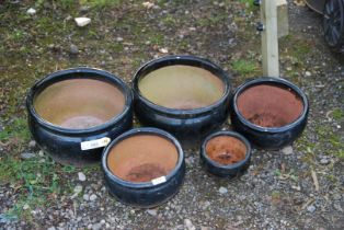 Five black glazed planters.