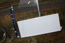 A radiator with threaded brackets, 55'' wide x 24'' high.