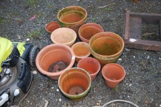 Ten terracotta pots.