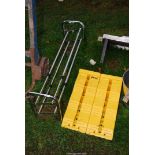 A shoe rack and two plastic wheel chocks.