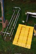 A shoe rack and two plastic wheel chocks.