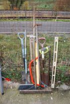 A spirit level, two bow saws, brushes, spade and shovel.