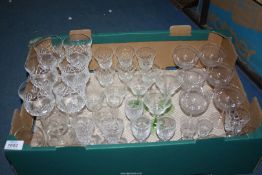 A quantity of glasses including six etched champagne coups, six cut glass sherry glasses,