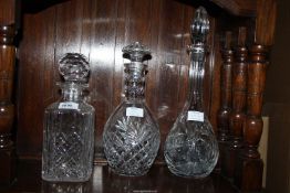 Three cut glass decanters.