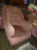 A buttoned back tub shaped easy Chair standing on turned front legs.
