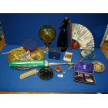 A quantity of miscellanea to include; an oil lamp with amber glass shade, hand mirror, manicure set,