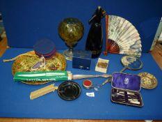 A quantity of miscellanea to include; an oil lamp with amber glass shade, hand mirror, manicure set,