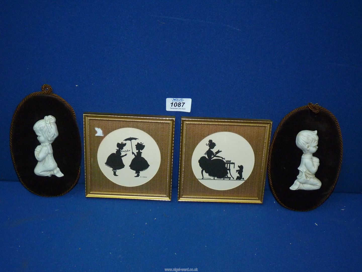 A pair of black silhouettes on card of young ladies signed G.A.