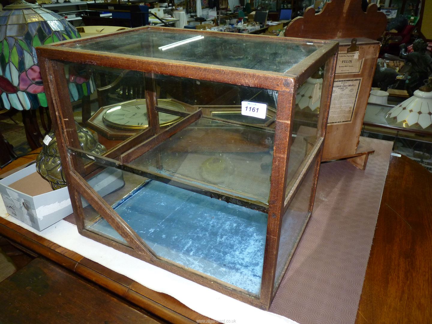 A two tier glass display Cabinet, 20" wide x 14" deep x 18" high (a/f).