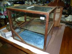 A two tier glass display Cabinet, 20" wide x 14" deep x 18" high (a/f).