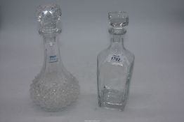 Two glass decanters with stoppers.