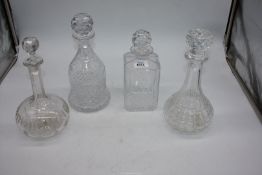 Four decanters; one bell shaped,bulbous shape plus two others.