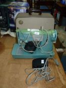 A vintage electric Singer sewing machine in case