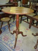 A light Oak circular occasional Table standing on a turned pillar with three splay feet,