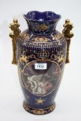 A large blue Vase with panels of cherubs and gold and multi colour raised detail, 14" tall.