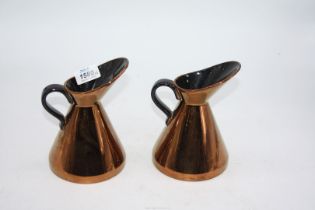A pair of gold Lustre ewer jugs; one Beswick, one Beswick ware.