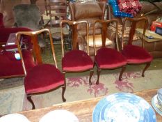 A set of four Satinwood framed Dining Chairs having shaped splats and cabriole front legs and