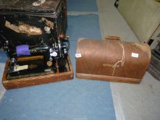 A vintage hand sewing machine in a wooden case.