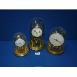 Three anniversary clocks including Bentime and Tempora, one with glass dome, two with plastic.