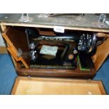 A Singer hand sewing machine, cased.