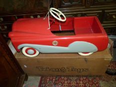 A vintage Tri-ang Toys Mobo T60 red and cream metal Pedal Car with original box.
