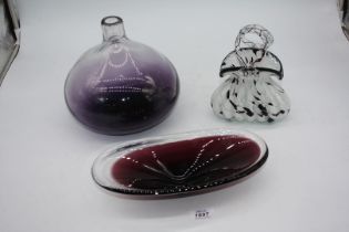 A purple frosted domed vase and oval bowl and a black and white 'handbag' vase.