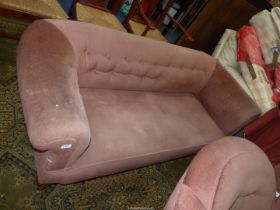 A beige buttoned upholstered Chesterfield type Settee on turned legs.