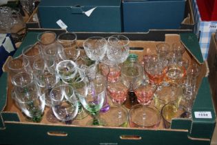 A large quantity of coloured glasses together with crocus bulb glasses and coloured shot glasses,
