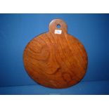 A Welsh chopping board of Elm wood, 17 1/2" diameter, slightly warped.