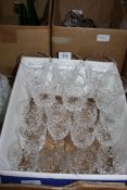 A quantity of cut glass stemmed wine glasses.