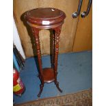 A circular Mahogany lamp Table having twist legs united by a lower shelf and with splay scroll feet,
